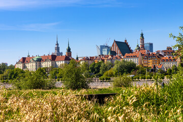 Fototapeta na wymiar Panoramic view of Warsaw, Poland, city center and Old Town quarter with Wybrzerze Gdanskie embankment and wild banks of Vistula river