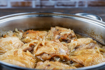 Chicken thighs fried in a pan, close-up, shallow depth of field, selective focus. Homemade food concept.