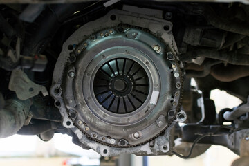 Car repair in a car service. Replacing the clutch of a gearbox on a car. New Clutch of a gearbox of...