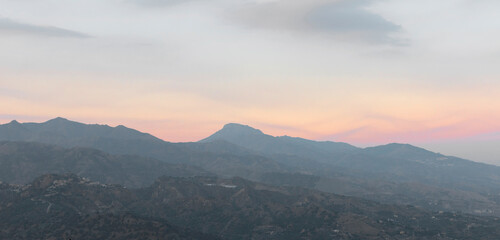 A view across the mountains with an early evening mist covering the valley in the Messina region of Sicily