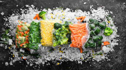 Assortment of frozen vegetables on ice. Stocks of food. Top view. Free space for your text.