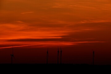 Fototapeta na wymiar Dunkles Abendrot, Sonnenenergie und Windkraft