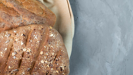 Fresh homemade wholesome bread on a gray background, close-up, top view on a gray background. Bread...
