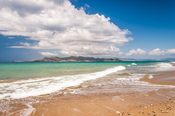 Beautiful golden sand beach with turquoise waters and a island and in the background. Kos island...