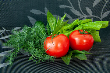 Vegetables on a plate. Tomatoes, lettuce, cucumbers, dill. Healthy nutrition, vegetarianism, vitamins.