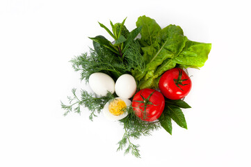 Vegetables on a plate. Tomatoes, lettuce, cucumbers, dill, eggs on a white background. Ingredients for the salad. Healthy nutrition, vitamins.