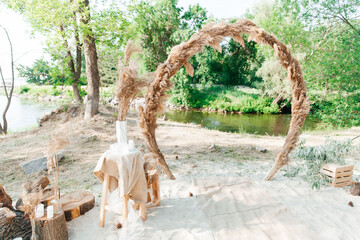 Wedding decor and arch, rustic style with straw and wedding rings