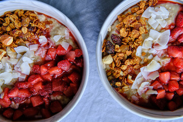 Healthy Vegan Homemade Breakfast. Oatmeal with strawberry sauce, coconut and granola.