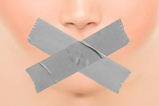 Woman Silenced With Adhesive Duct Tape Covering Closed Mouth. Censorship, Shut Down Of Freedom Of Speech. Face Nose And Lips.