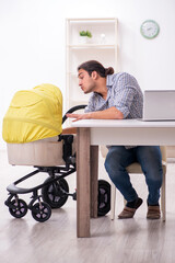 Obraz premium Young father looking after newborn baby at home