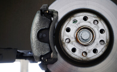 Brake disc, brake caliper mounted on a modern car. Concept of service and car repair.