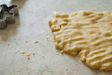 Mother and daughter making gingerbread man on the kitchen