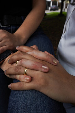 brides hands lesbians interlaced women's hand showing their wedding ringstwo interlaced women's hand showing their wedding rings