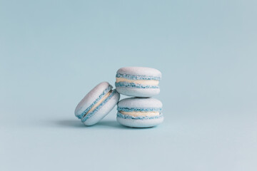 Tasty french macaroons on a light blue pastel background.
