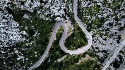 A top-down aerial view on mountainous curvy road Nus de Se Calobra, famous and dangerous zig zag...
