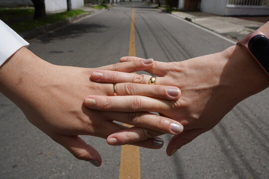 brides hands lesbians interlaced women's hand showing their wedding rings