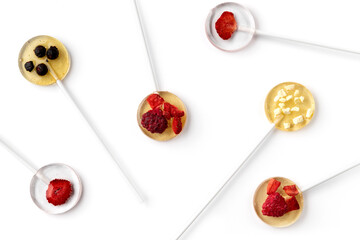 Homemade lollipops made from natural dehydrated berries on white background