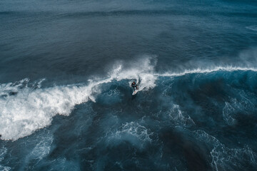 Surfing in a volcanic beach