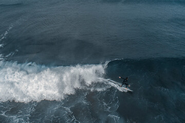 Surfing in a volcanic beach