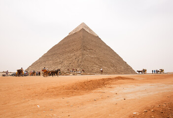 Fototapeta na wymiar GIZA, EGYPT, APRIL 20: Tourists visits the second largest Pyramids of Kahfre at Giza complex, Cairo, Egypt on April 20, 2018