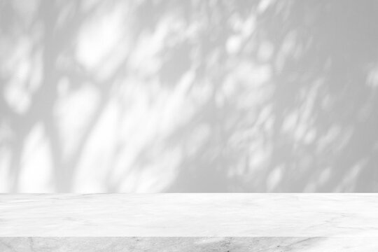 White Marble Table with Tree Shadow on Concrete Wall Texture Background, Suitable for Product Presentation Backdrop, Display, and Mock up.