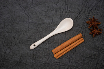 White glazed porcelain coffee spoon on artificial leather background.