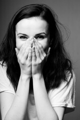 beautiful girl in a white T-shirt smiles, laughs. Black and white photography