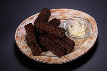 Black crouton with garlic sauce