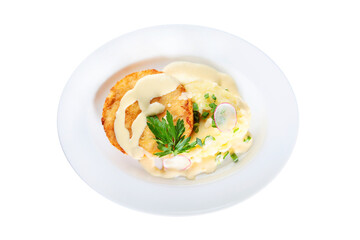 Breaded chicken cutlet with mashed potatoes on a white plate. An isolated object.Top view.