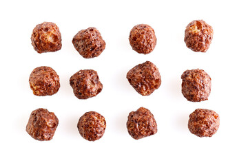 Chocolate corn balls isolated on white background. Chocolate balls dry breakfast scattered on a white background. Space for text. Also known as Chocolate flakes. Full depth of field.