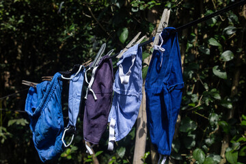 A clothesline with some masks that have been washed