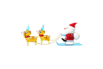 Miniature Glass Reindeers and Santa Sitting on Sled Isolated on White Background.