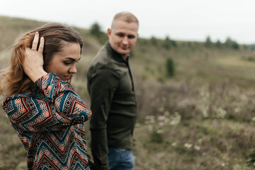 Young woman touching hair with hand when her boyfriend is looking at her. Happy couple