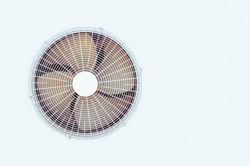 Condenser unit coil fan of an air conditioner. White outer air conditioner device
