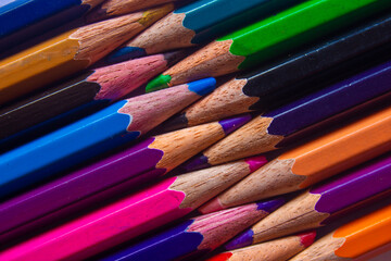 Color pencils arranged in a creative way. Student art supplies.