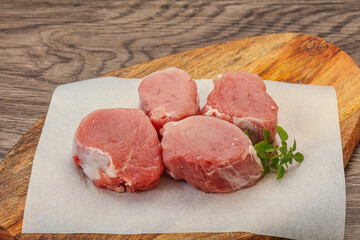 Raw pork medallion served rosemary