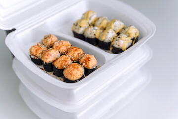 Hot baked rolls in a plastic box close up. Delivery service consept.