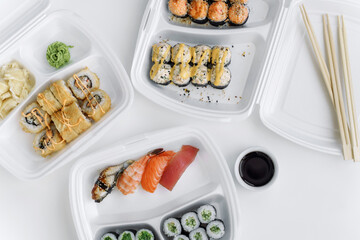 Set of rolls and sushi in a plastic box close up. Delivery service consept.