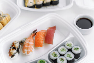 Sushi and rolls in a plastic box close up. Delivery service consept.