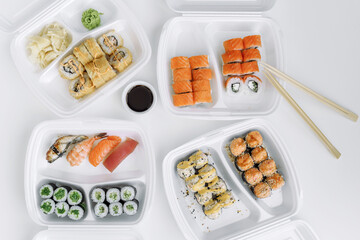 Set of rolls and sushi in a plastic box top view. Delivery service consept.