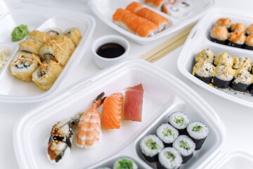 Set of rolls and sushi in a plastic box close up. Delivery service consept.