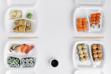  Sushi and rolls set in a plastic box (top view). Delivery service consept.