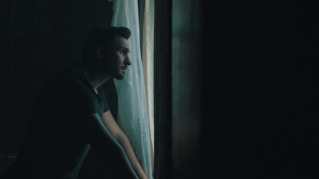 man ponders in an old Soviet apartment