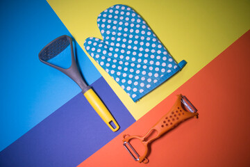 Beautiful bright kitchen accessories on a colored background