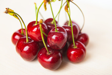 Ripe cherries on wooden surface