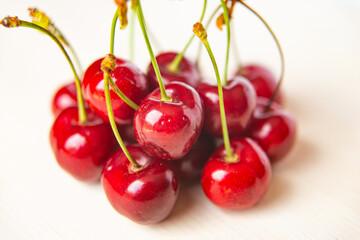 Ripe cherries on wooden surface