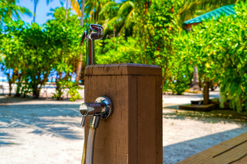 Metal round shower on a water villa on tropical island resort