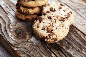 Chocolate cookies on wooden table. Chocolate chip cookies shot on vintage background
