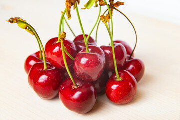 Ripe cherries on wooden surface