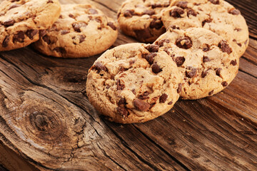 Chocolate cookies on wooden table. Chocolate chip cookies shot on vintage background